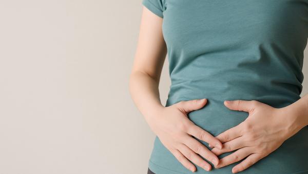 Donna con le mani sulla pancia – articolo su cibi che gonfiano la pancia